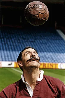 Heading Prints: Liverpool footballer Ian Rush wears the Liverpool strip of 100 years ago including fake