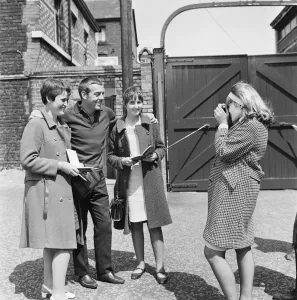 Liverpool footballer Ian St John has his photograph taken by teenager Irene Kevan as he