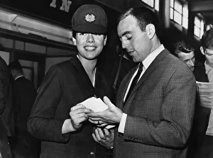 Liverpool footballer Ian St John signs an autograph for air hostess Jeanette Sutherland