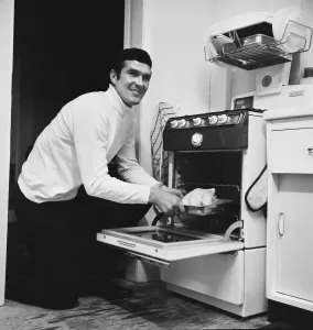 Liverpool footballer Ron Yeats poses at home with his new gas cooker