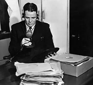 Microphone Prints: Liverpool forward and captain Billy Liddell speaking in to a microphone as he runs a