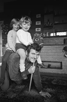 Guns Prints: Liverpool goalkeeper Tommy Lawrence playing with his young son Stephen