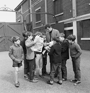 Liverpool goalkeeper Tommy Lawrence sign autographs for fans outside Anfield football