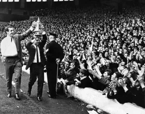 Applause Prints: Liverpool injured footballers Gerry Byrne and Gordon Milne parade the FA Cup trophy to