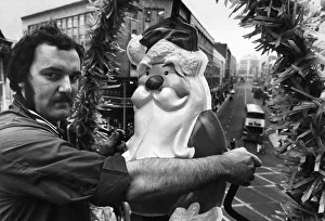 One Mid Adult Man Only Prints: Liverpool lighting engineer Frank Fox seen here installing the first of many of