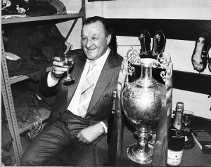 Liverpool manager Bob Paisley celebrates with a glass of champagne in the dressing room
