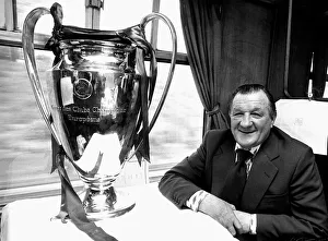 Liverpool manager Bob Paisley withthe European Cup trophy sitting on a train following
