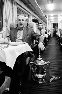 Liverpool manager Bill Shankly with the FA Cup trophy on board the train back to
