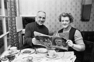 Liverpool manager Bill Shankly pictured at home with his wife reading a feature