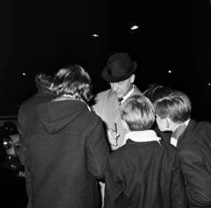 Liverpool manager Bill Shankly signs autographs for young fans as the team arrives home