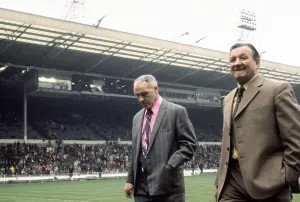 Liverpool manager Bill Shankly walks on to the pitch accompanied by Bob Paisley