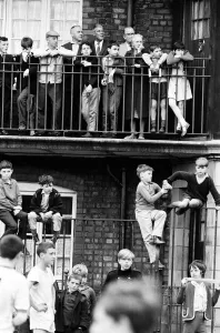 00461 Prints: Liverpool mananer Bill Shankly watches a game of Street football from a flat above Eldon