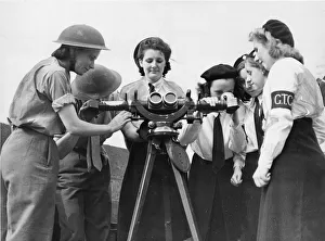 The Auxiliary Territorial Service Prints: Liverpool members of the Girls Training Corps displaying a keen interest in an instrument