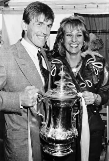 Liverpool player manager Kenny Dalglish holding the FA Cup trophy with his wife Marina