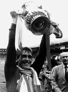 F A Cup Prints: Liverpool player manager Kenny Dalglish holding the trophy aloft after their win against