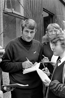 00255 Prints: Liverpool player Roger Hunt signing autographs for fans. November 1969 Z10571