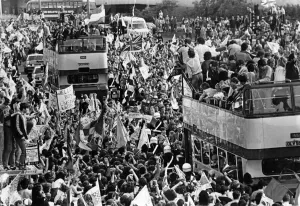 Parades Prints: Liverpool players proudly show off the European Cup trophy to thousands of fans who lined