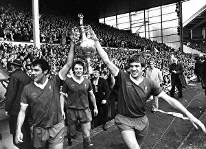 Liverpool players Ray Kennedy (L) and Emlyn Hughes celebrate with the League Championship