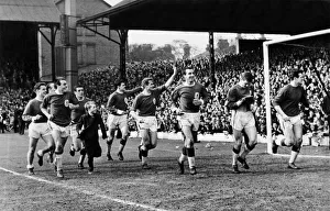 Liverpool players salute their fans in the Anfield Road stand on a lap of honour after