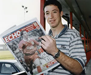 01296 Prints: Liverpool striker Robbie Fowler reading the Liverpool Echo Special Celebration Souvenir