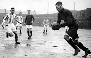 Liverppol goalkeeper Elisha Scott clears the ball after a shot from Huddersfield Town