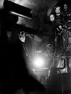 LNER train driver Mr Doughty, checks for his signals while driving his train