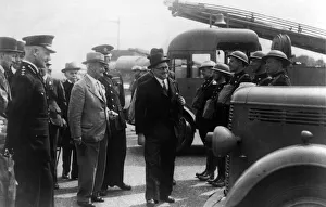 A local mayor inspecting an auxiliary fire fighting crew. Circa 1940