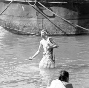 Locals bath in the Buriganga River Dacca, Bangladesh. February 1961 l
