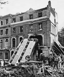 A London double decker bus hit by the blast from a bomb dropped during an air raid