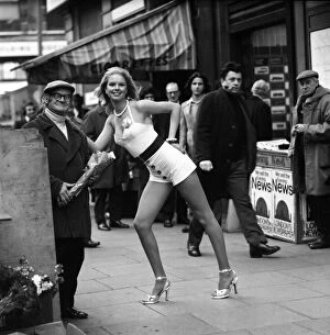Images Dated 16th January 1975: A London flower seller says it with flowers when he met model Christine Donna