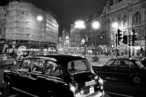 London taxis around Picadilly Circus at night. February 1987
