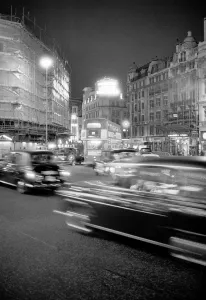 London taxis around Picadilly Circus at night. February 1987