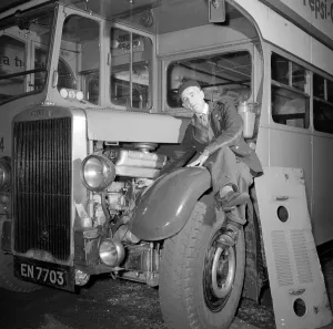 London Transport mechanic seen here checking the engine of a Leyland bus