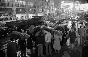 Commuters Prints: London travellers are soaked by the rain as the end of the 1976 drought is officially