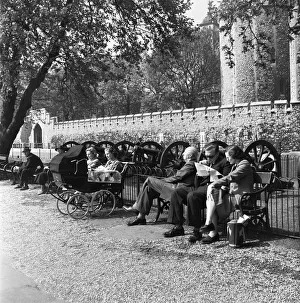 Londoners enjoy the early summer sun on the banks of the River Thames by the Tower of
