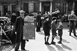 Londoners file pass the Sir William Reid Dicks statue of FDR shortly after it was