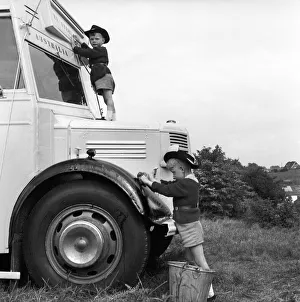 00077 Prints: Long distance bus journey. The Drew family seen here with their converted bus in which