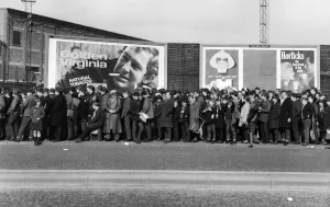 A long line of football fams queuing up to enter the stadium before a match in the North