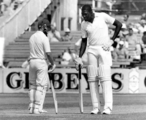 Size Prints: The long and short of it. Joel Garner and Gard hold mid wicket conference. P006189. c