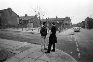 Lord Gifford talks to local resident Delroy Burris in Granby Street, Toxteth