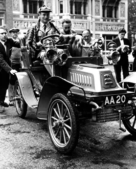 Lord Montagu of Beaulieu July 1958 at the wheel of his car as it is manhandled into