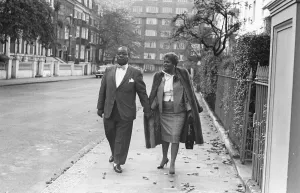 Louis Armstrong seen here arriving for a press conference at the Mayfair Hotel