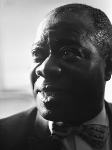 Louis Armstrong seen here giving a press conference at the Mayfair Hotel