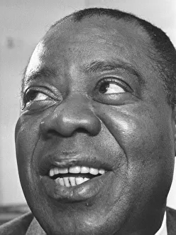 00278 Prints: Louis Armstrong seen here giving a press conference at the Mayfair Hotel