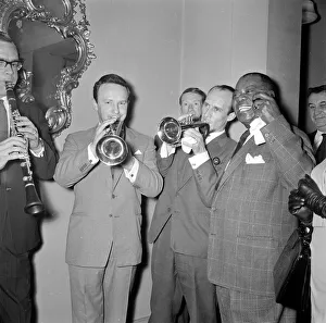 Louis Armstrong seen here with sernaded by a jazz trio during the Daily Mirror lunch for