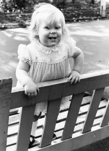 00029 Prints: Louise Brown Test Tube Girl standing on park bench October 1979