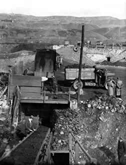 00026 Prints: Louise tipping coal through a grid to a conveyer at an open cast coal working