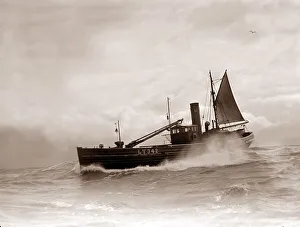 A Lowestoft Herring boat ploughing through a moderate swell in the North Sea. Circa 1935