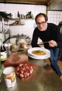 Loyd Grossman TV Presenter of Master Chef in his wn kitchen trying out his own cooking