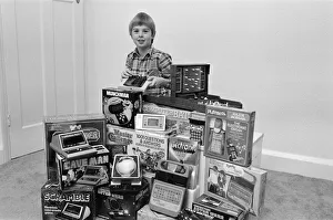 Electronic Prints: A lucky child surrounded by a selection of electronic games available in the shops this